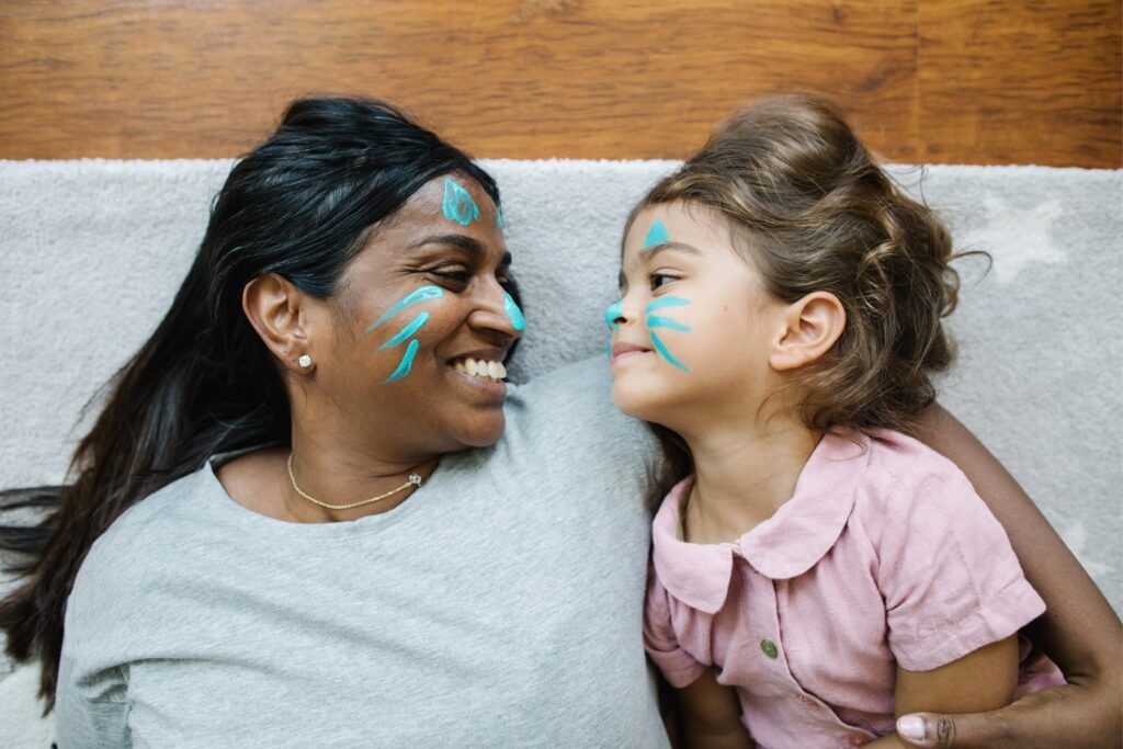 adult and child with faces painted