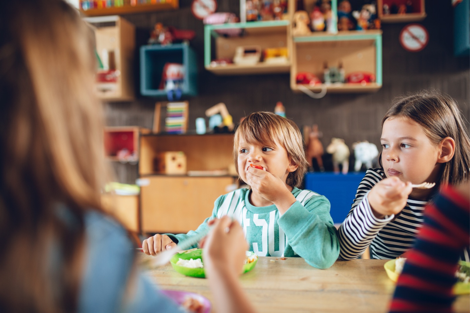 Two young children eating at a table