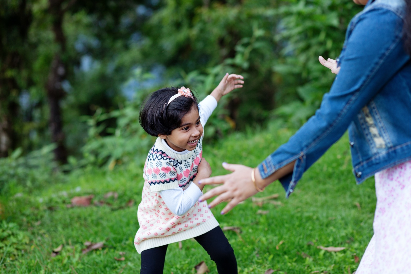 Young girl running to adult in play